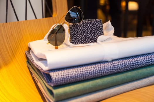 View of men's shirts, necktie and shades
