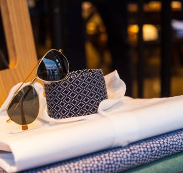 View of men's shirts, necktie and shades