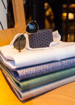 View of men's shirts, necktie and shades