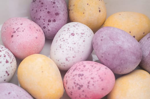 Close-up of several colorful Easter eggs in pastel colors