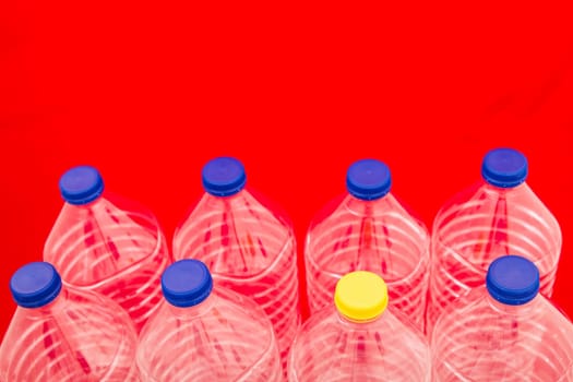 Empty bottles of mineral water, one with a different lid.