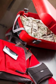 A Suitcase with lots of dollars, ready for business.