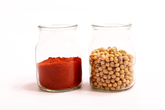 Paprika and soya beans in glass pot.