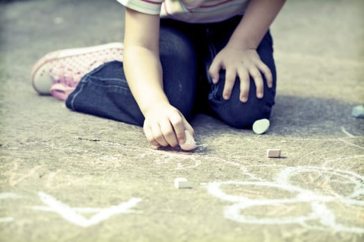 Back to school concept -Photo of girl writing with chalk on the schoolyard