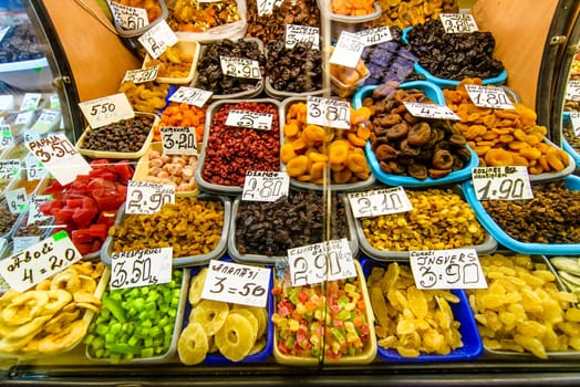 dried multi color exotic fruit on the market with visible prices,many different fruits.