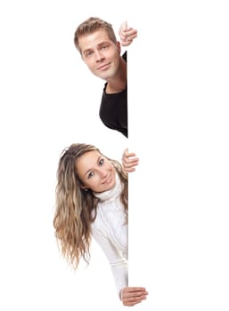 Young cheerful couple holding an empty board