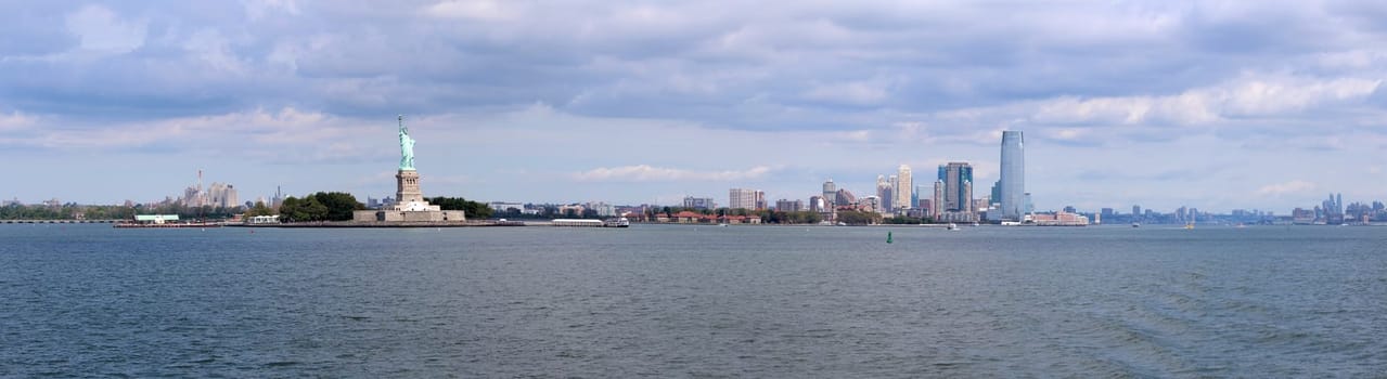 The Statue of Liberty (Liberty Enlightening the World), a colossal neoclassical sculpture on Liberty Island in the middle of New York Harbor, Manhattan. The statue is of a robed female figure representing Libertas, the Roman goddess of freedom, who bears a torch and a tabula ansata