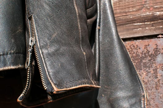 Vintage leather male jacket sleeve on old  railway wagon background