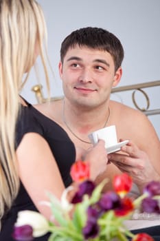 Happy Couple on bed with coffee