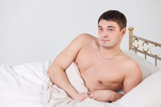 Shirtless man on the bed - shot in studio