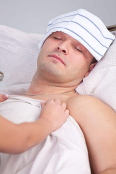 Woman nursing a sick man on the bed