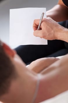 Sick man in bed signs empty paper or testament