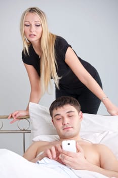 man is cheating on phone while woman looking over his shoulder