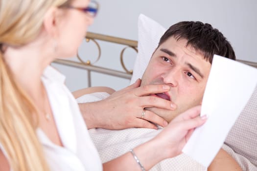 Shocked man on bed after a medicine report