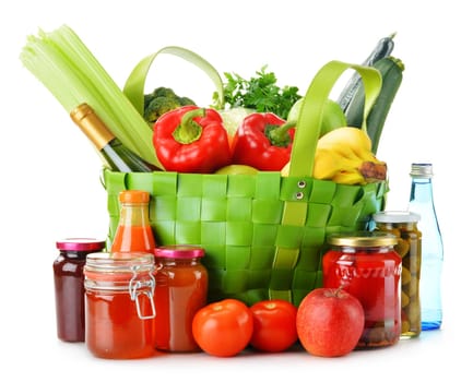 Green shopping bag with groceries isolated on white background