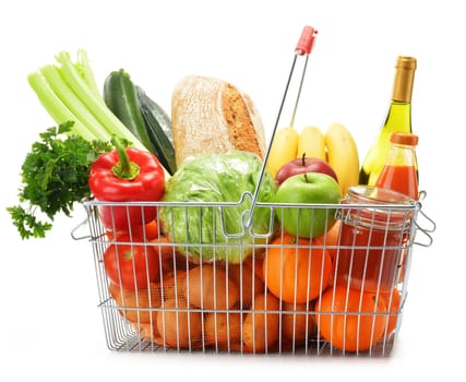 Wire shopping basket with groceries isolated on white