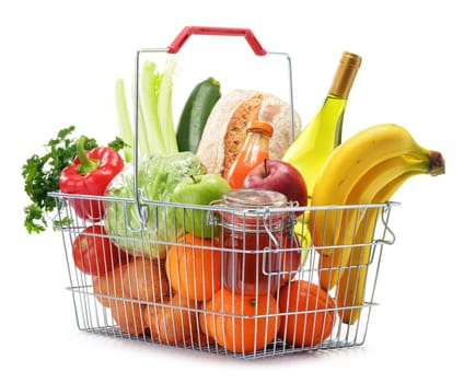 Wire shopping basket with groceries isolated on white