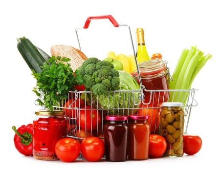 Wire shopping basket with groceries isolated on white