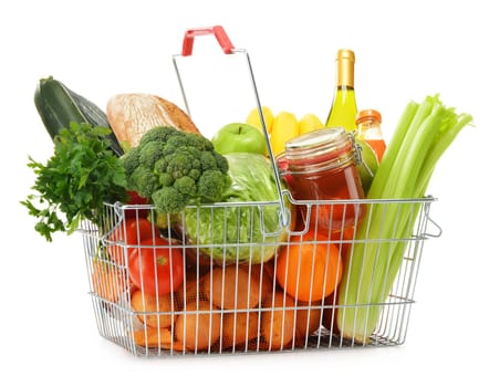 Wire shopping basket with groceries isolated on white