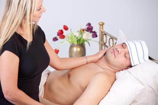 Sick man on bed - woman nursing him