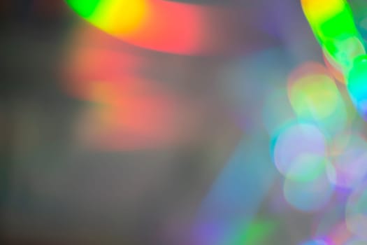 Rainbow holographic bokeh background. Multicolored overflows of color.