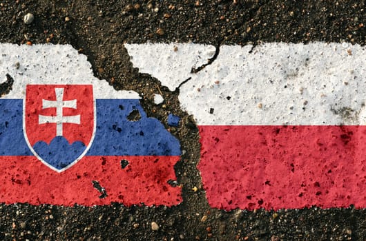 On the pavement are images of the flags of Poland and Slovakia, as a symbol of confrontation. Conceptual image.