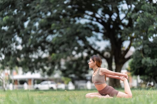 Asian woman wearing sportwear doing Yoga exercise in the nature.
