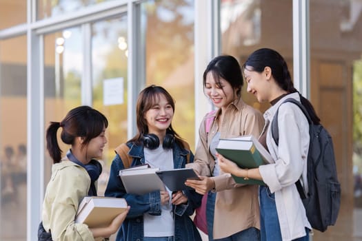 University students reading books and tutoring special class while walking to next class.