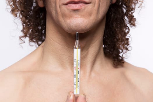 Cropped portrait of mediterranean looking man holding a mercury thermometer