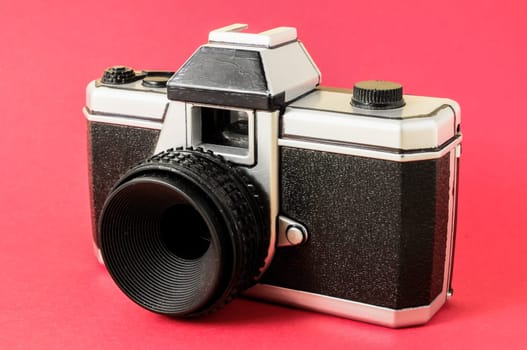 Classic 35mm Plastic Toy Photo Camera on a Colored Background