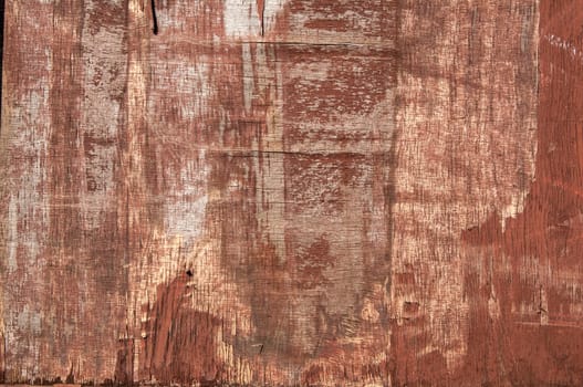 Old weathered plywood surface with faded paint as background