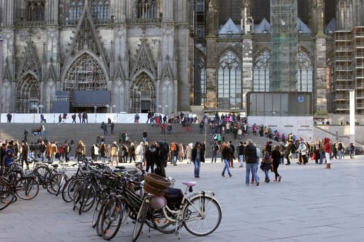Cologne,Germany – February 02,2014: Tourists and travellers on the station forecourt walk up the stairs to Cologne Cathedral on February 2,2014 in Cologne.
