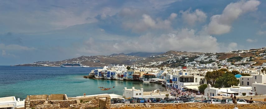 A gorgeous panorama picture of the island on Mykonos Greece with the.harbour and the city of Fira..