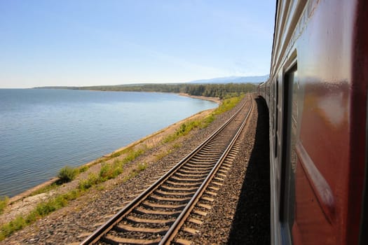 A train of the Trans Siberian Railway is passing lake Baikal in Siberia, Russia