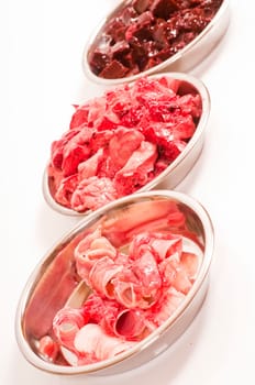 fresh cut offal (liver,lungs,heart,throat,spleen) for raw feeding in stainless steel bowls