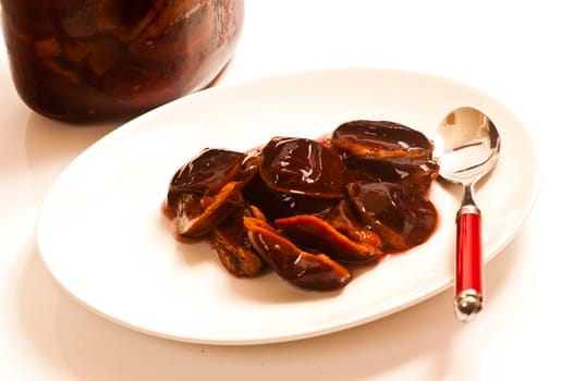 Preserved and fresh plums with cinnamon