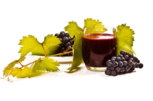 freshly squeezed red grape juice with vine leaves on a white background