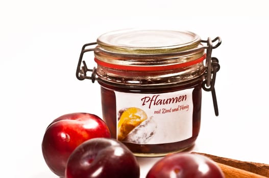 Preserved and fresh plums with cinnamon