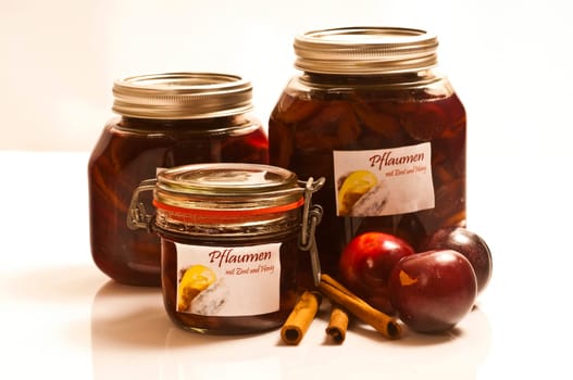 Preserved and fresh plums with cinnamon