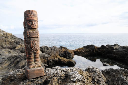 Ancient Maya Statue on the Rocks near Ocean