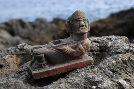 Ancient Maya Statue on the Rocks near Ocean