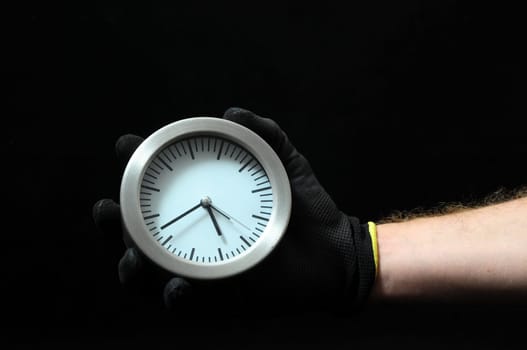Clock And an Hand on a Black Background