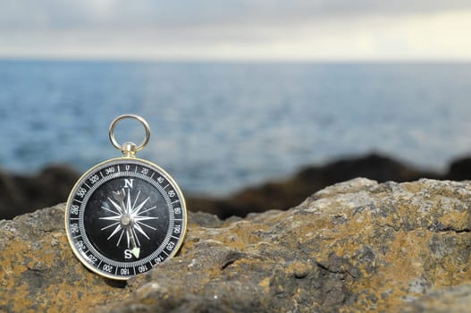 Orientation Concept - Analogic Compass Abandoned on the Rocks