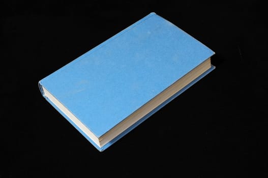 One Empty Book Isolated on a Black Background