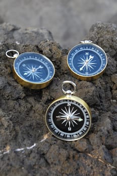 Orientation Concept - Analogic Compass Abandoned on the Rocks