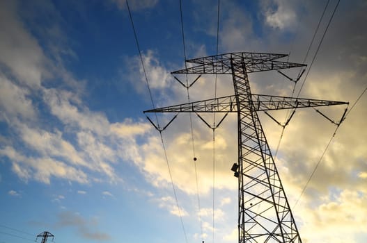 Power Electric Tower on a Cloudy Sky at Sunset