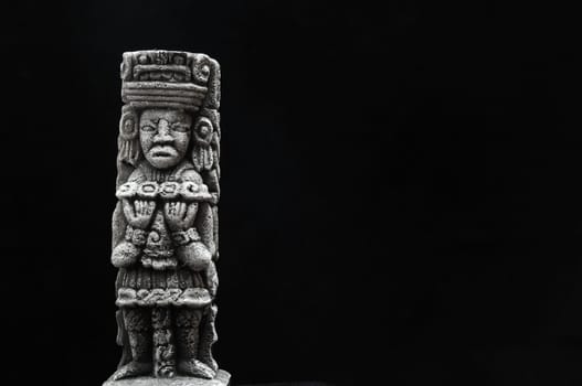 One Ancient Mayan Statue on a Black Background