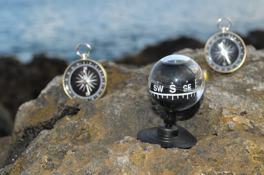 Orientation Concept - Analogic Compass Abandoned on the Rocks