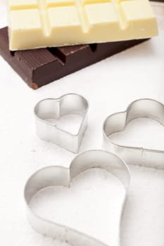 Heart-shaped cookie cutter on flour base