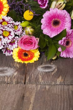 Bouquet of flowers on rustic wooden background